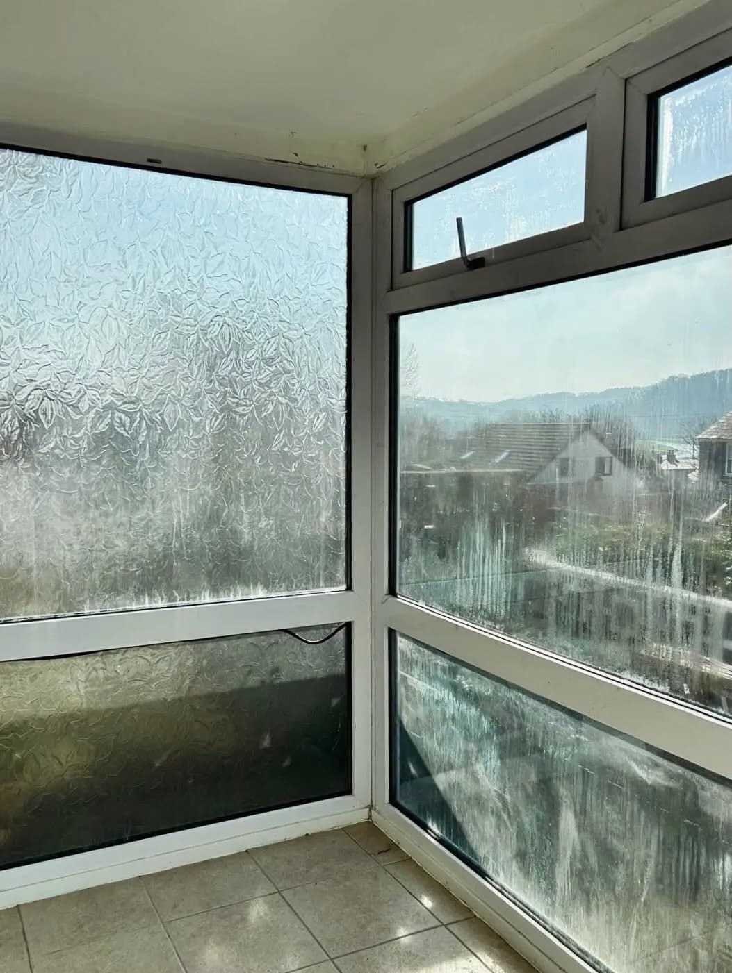 A misted double glazed window with condensation trapped between the panes
