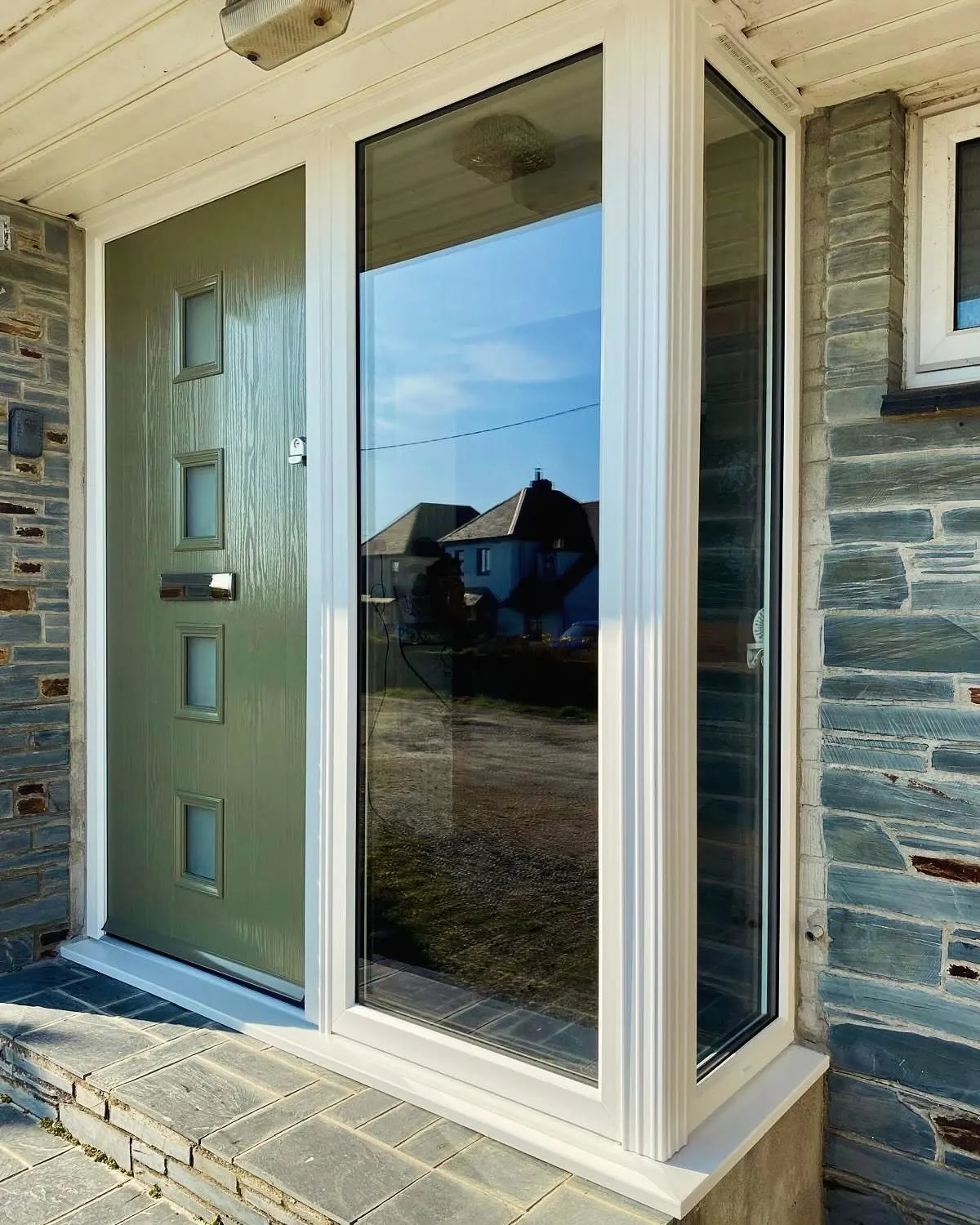 A newly fitted olive green composite front door