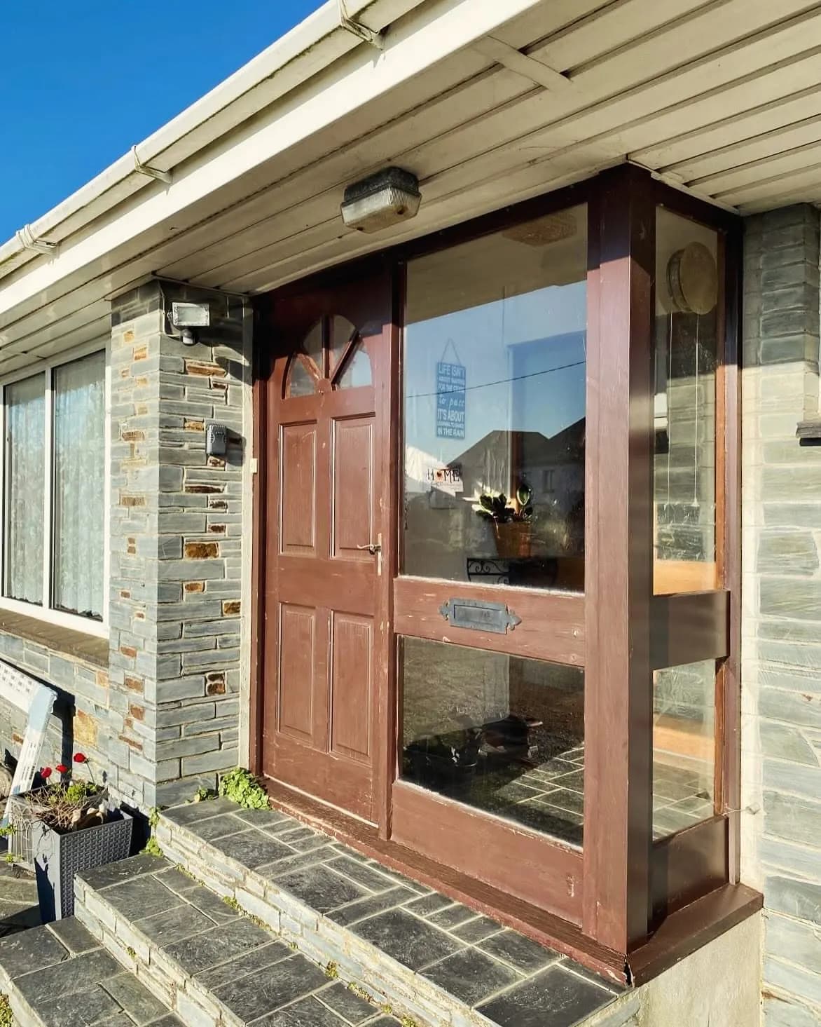 A timber front door in a slate fronted Cornish porch after repair
